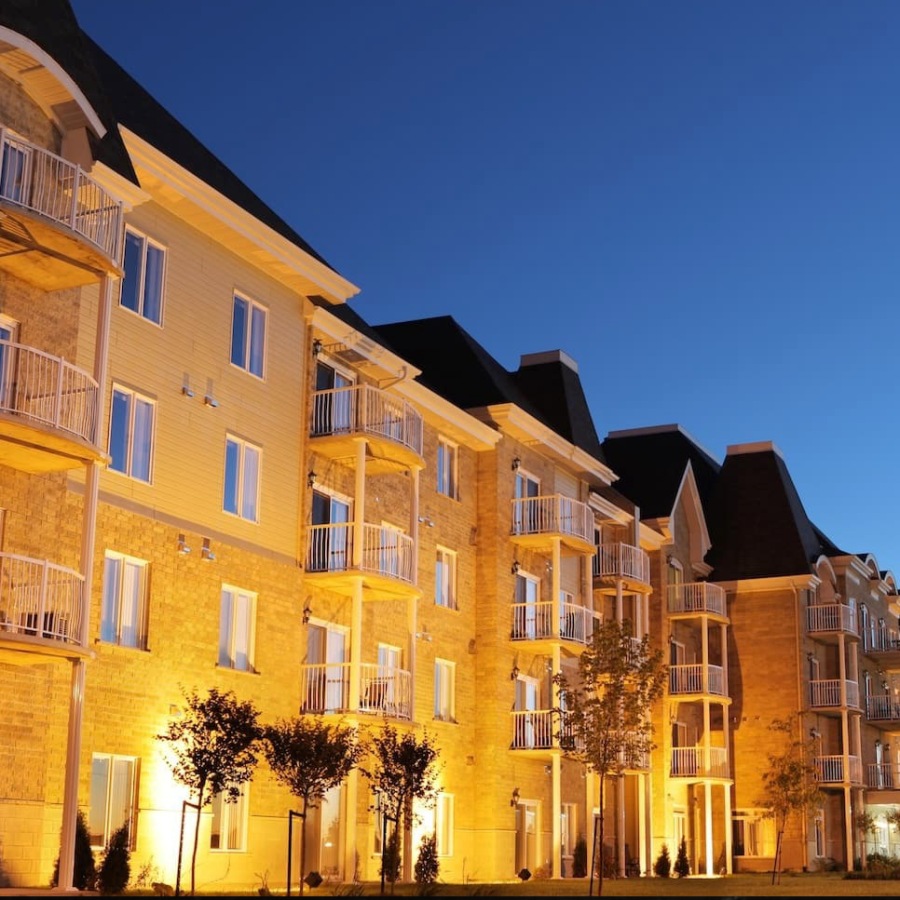 exterior of a large multifamily building at sundown